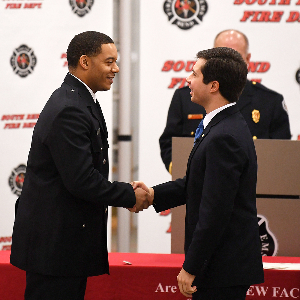 Mayor Pete shakes hands with a firefighter during Fire Recruit Graduation