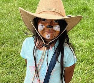 A child with her face painted like a tiger at the Linden Avenue Farmer's Market